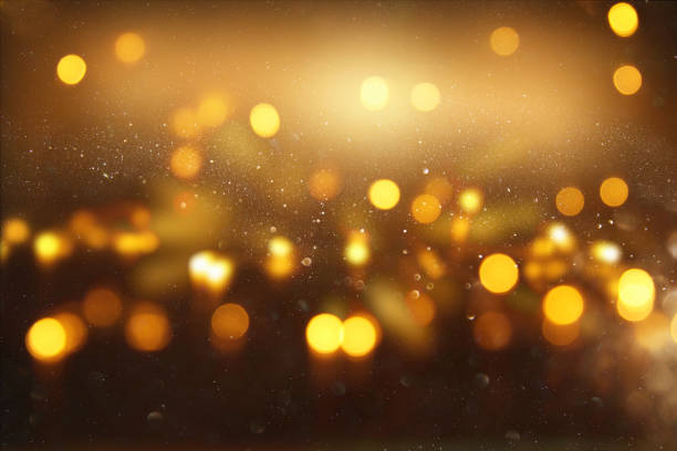 istock Gold and black glitter lights background. defocused. 911325942