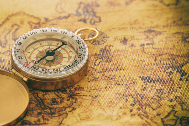 istock image of old compass over vintage map. selective focus. 911325958