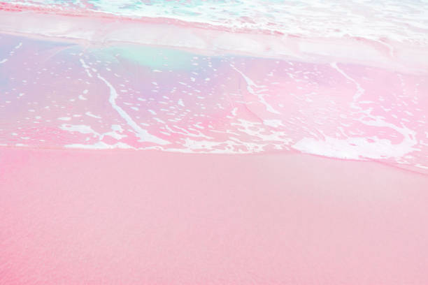 istock Foamy Clear Ocean Wave Rolling to Pink Sand Shore Turquoise Blue Water. Beautiful Tranquil Idyllic Scenery. Tropical Beach Vacation Relaxation Paradise. Copy Space Elegant Styled Toned Image 911329562