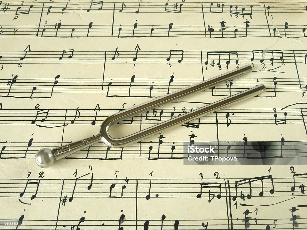 Fork on old sheet music  Tuning Fork Stock Photo