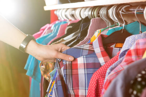 istock Clothes hanging on the rack in the store 911332570