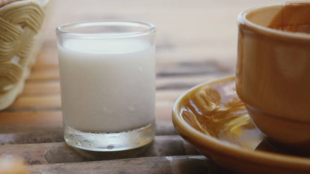 istock Milk and a cup of espresso on wooden table. 911337520