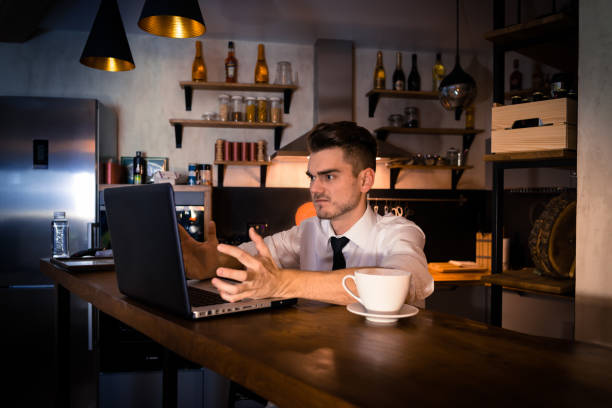 istock Dissatisfied young man sits in the kitchen at the bar 911340492