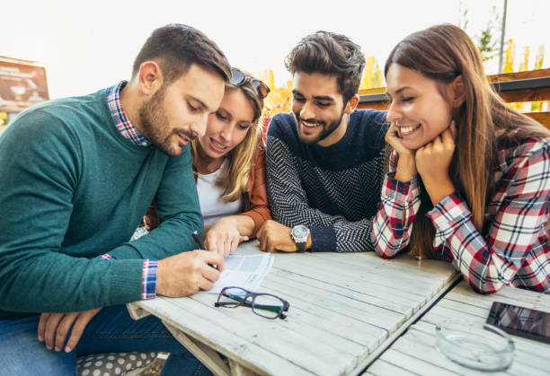 istock Group of four friends having a coffee together 911340890