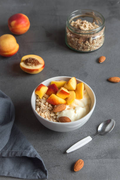 istock oatmeal granola with yogurt and peaches 911343960