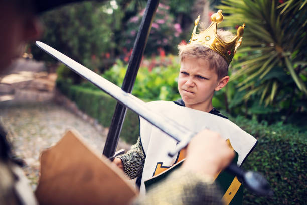 istock Young king practicing swordplay in the castle gardens 911344240