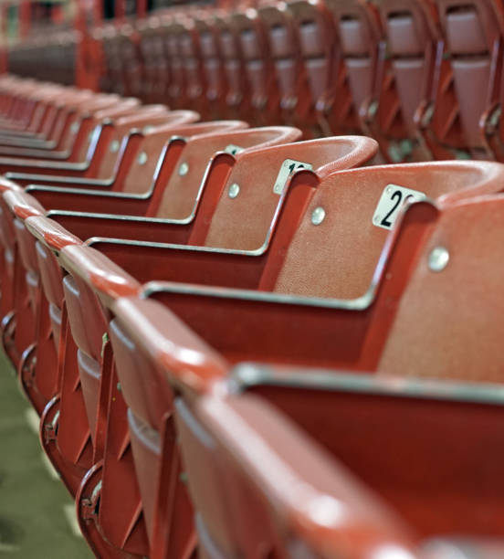 istock Red stadium seats in an empty arena 911345428