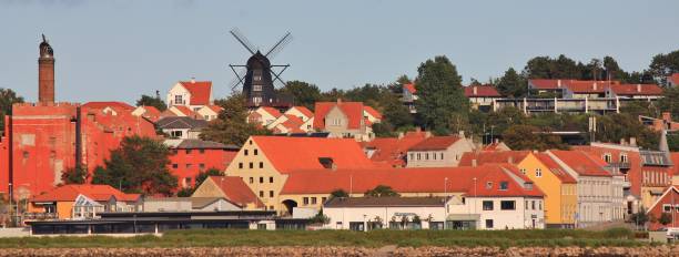 Old factory and beautiful black windmill in Ebelstoft, Djursland. Town at the east coast of Denmark.