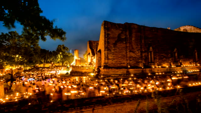 People do dhamma with Light Waving of Candle Rite Walk TL on Visakha Puja Day in Ayutthaya, Thailand.