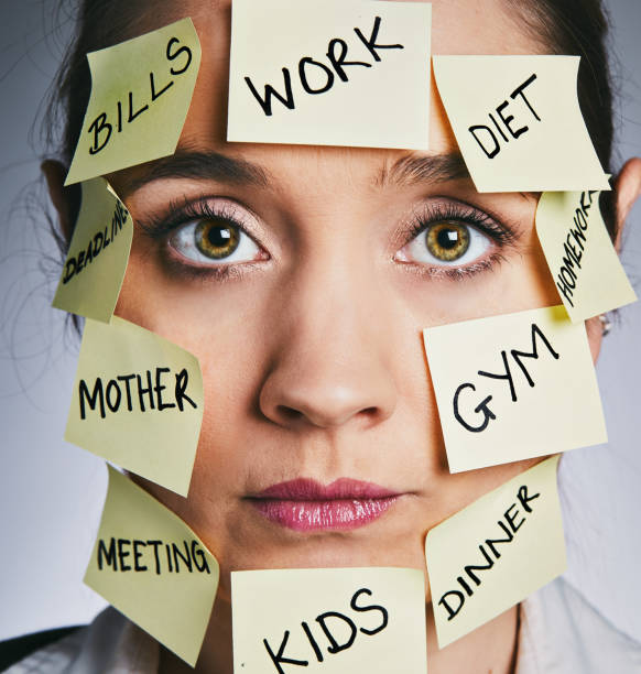 istock Multi-tasking woman looks serious and grim-faced 911350898