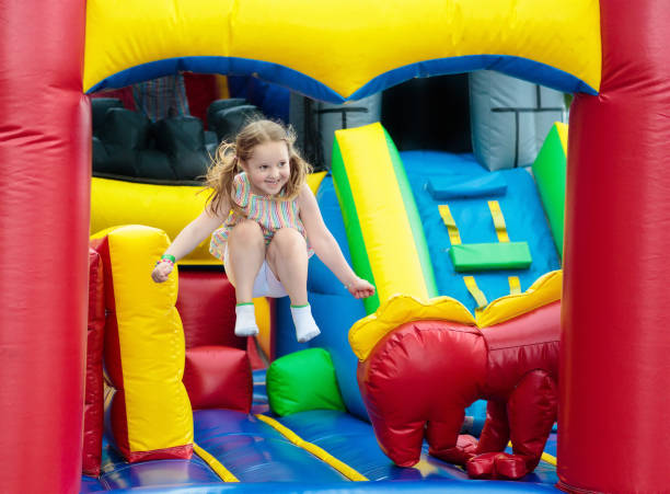 istock Child jumping on playground trampoline. Kids jump. 911351884