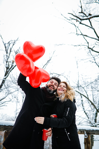 Couple in love with balloons - winter day of St. Valentine