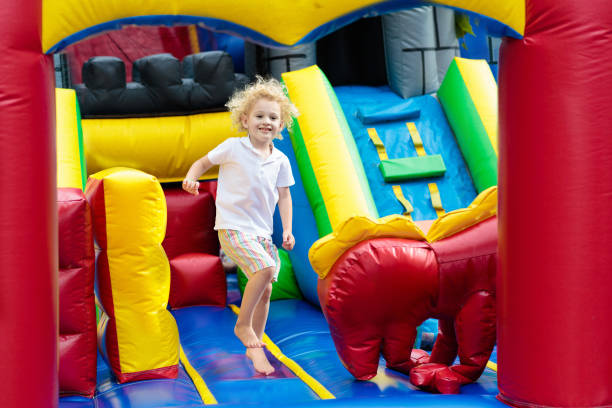 istock Child jumping on playground trampoline. Kids jump. 911352250