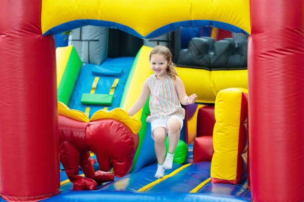 istock Child jumping on playground trampoline. Kids jump. 911352270