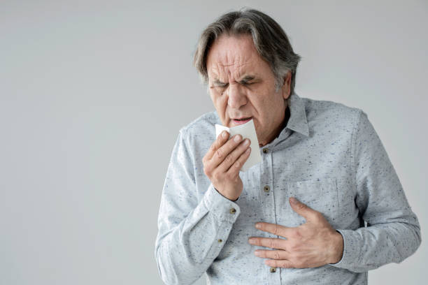 Old man coughing to tissue Old man coughing to tissue coughing photos stock pictures, royalty-free photos & images