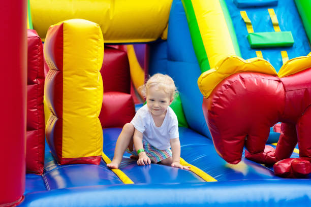 istock Child jumping on playground trampoline. Kids jump. 911352470