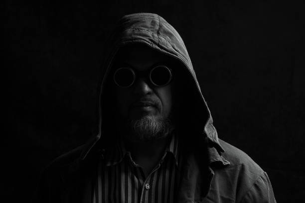 istock dark portrait of a man in a hood 911360708