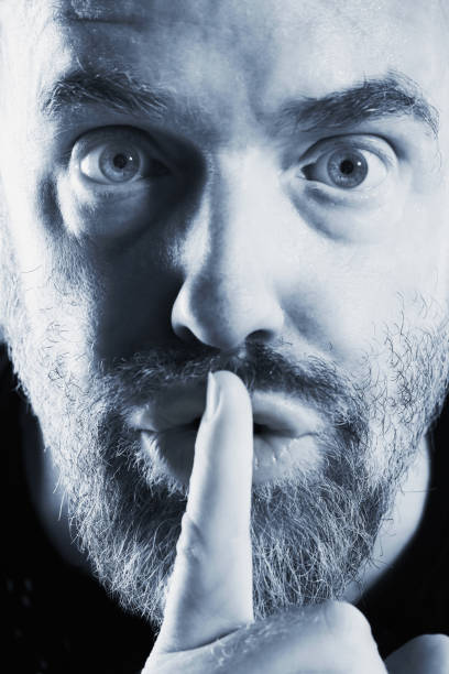 istock Shhh! Finger on lips, man urges silence 911363008