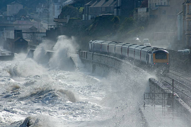 High speed train leaving Dawlish in a storm stock photo