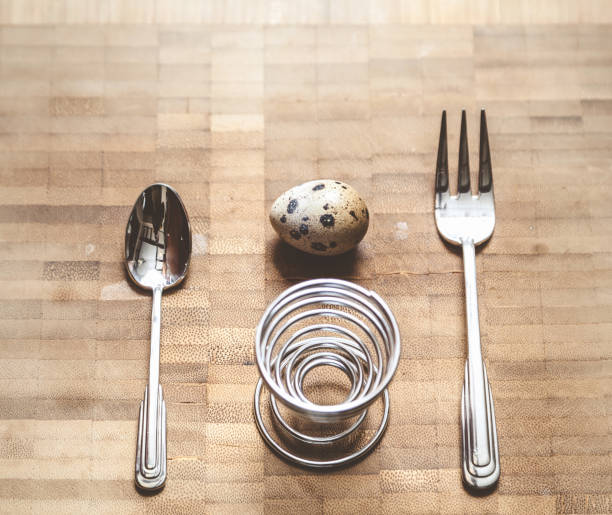 Egg quail, helical rack and equipment on board Egg quail, spiral stand, fork, spoon lie on the board. Set for dietary breakfast helical stock pictures, royalty-free photos & images