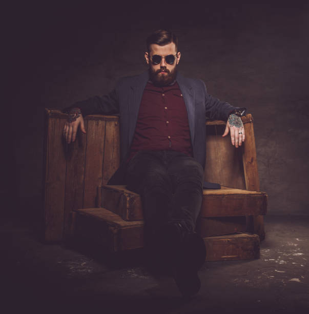 istock Hipster man in sunglasses posing in dark light. 911393976