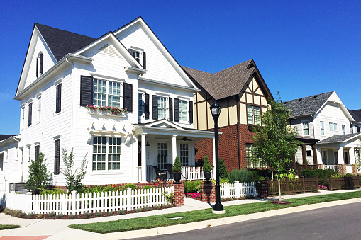 Front exterior of a large greyish blue new home in Virginia.