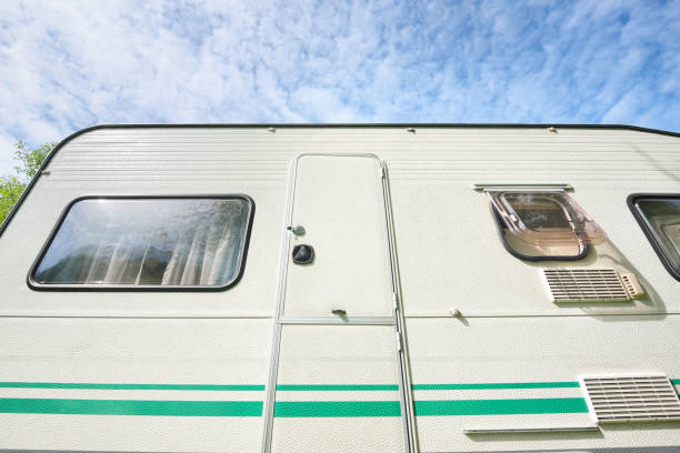 istock Caravan trailer against blue sky with clouds 911397652