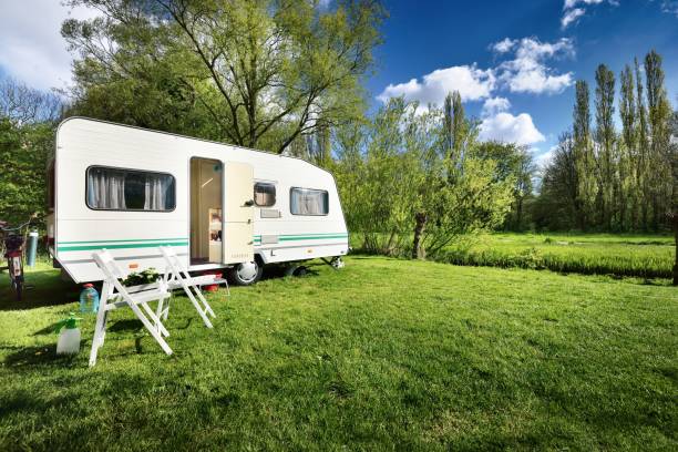 istock Caravan trailer on a green lawn, on a sunny spring day 911397676