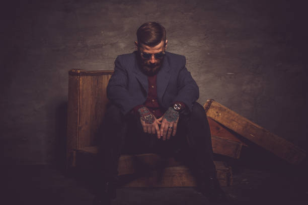 istock Hipster man in sunglasses posing in dark light. 911399656