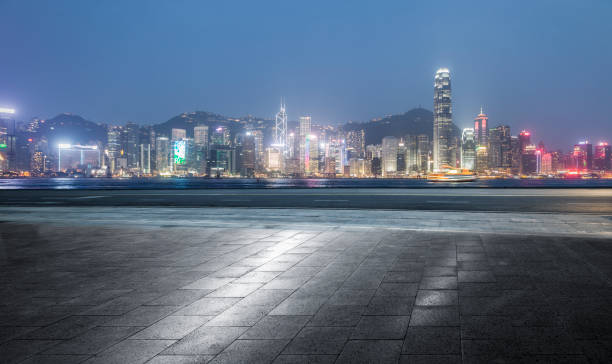 istock empty tile floor front of Hong Kong illuminated skyline 911412426