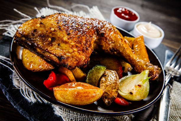 istock Roast chicken leg on wooden background 911415898