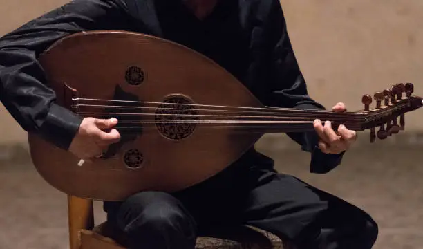 Oud Player with black suit