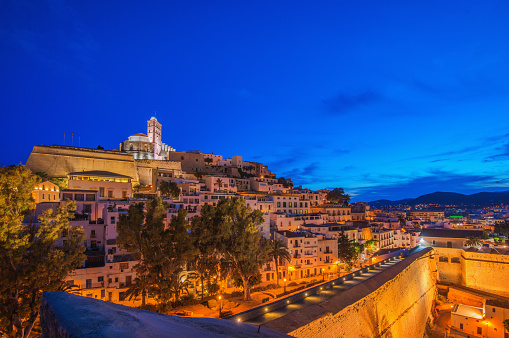 View on the the historic, old, fortified town of Eivissa (Ibiza town), called Dalt Vila (Upper Town) with its landmark church, Catedral de Santa María. at dusk.