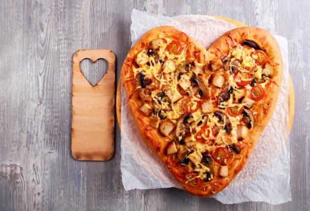 istock Heart shaped pizza with chicken and mushrooms 911422878