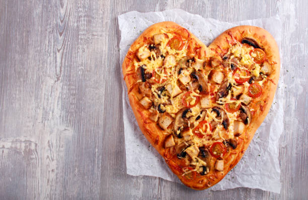 istock Heart shaped pizza with chicken and mushrooms 911426004
