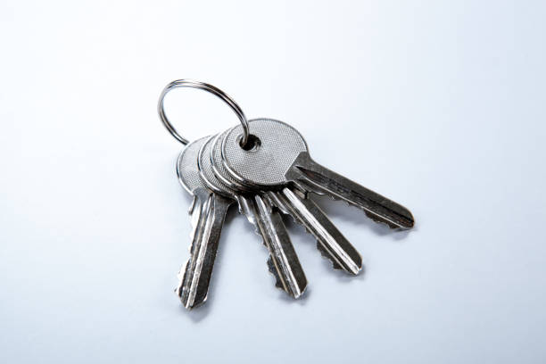 istock keys from the apartment on a white table closeup 911438604