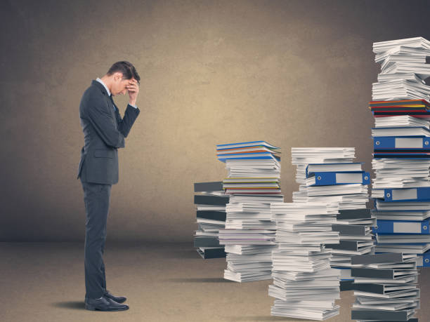 Businessman in despair Tired businessman with stack of office files face down stock pictures, royalty-free photos & images