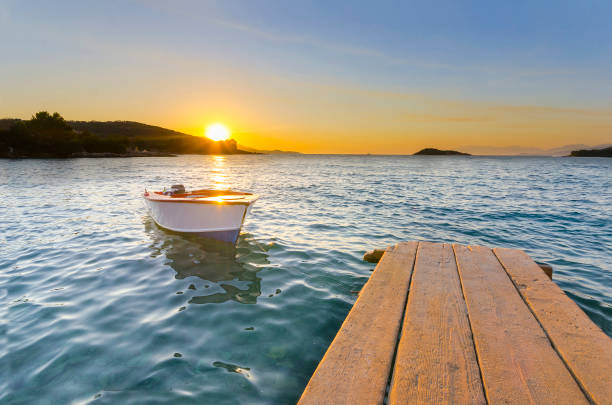 istock Small Dock and Boat at the lake, sunset shot 911439422