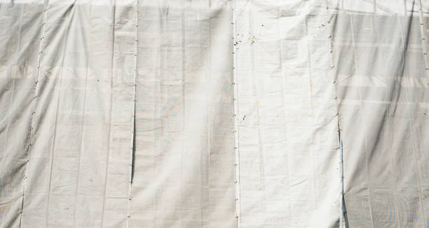 istock Construction scaffolding and white debris netting in the city 911442152