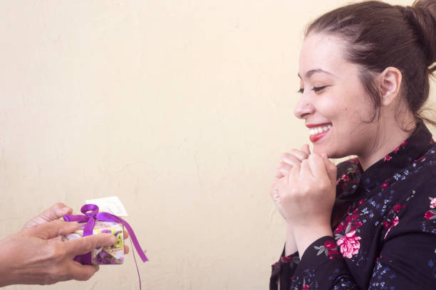 istock a mother giving a valentine's gift for her beautiful daughter 911442218