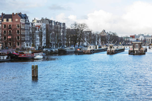 istock Typical Dutch houses built by the canal, Amsterdam, Netherlands 911444750