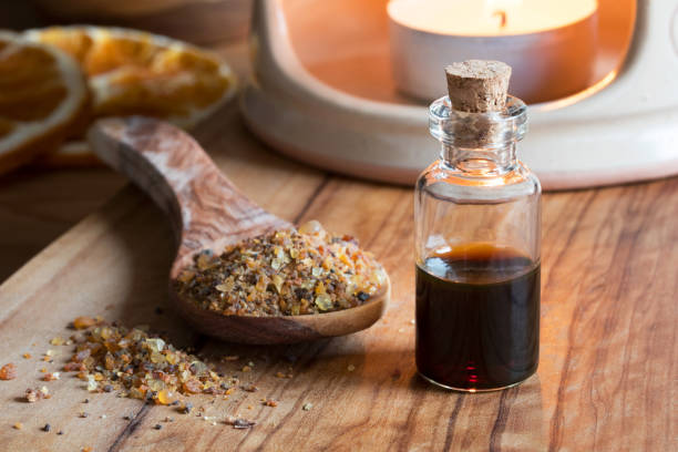 a bottle of myrrh essential oil with myrrh resin - tree resin imagens e fotografias de stock