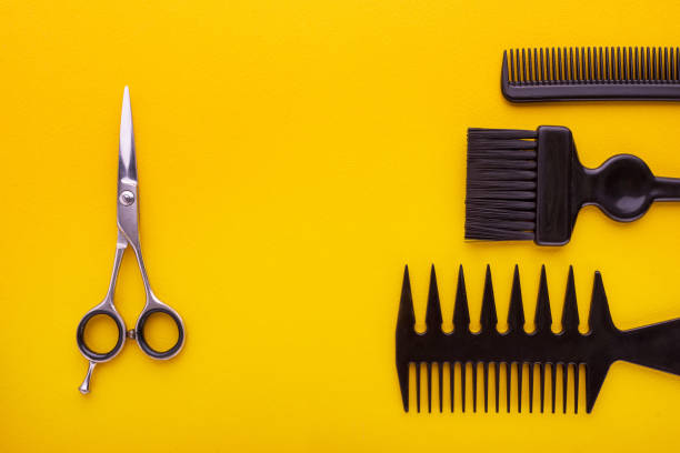 istock scissors and combs on yellow, hairdresser concept 911459404