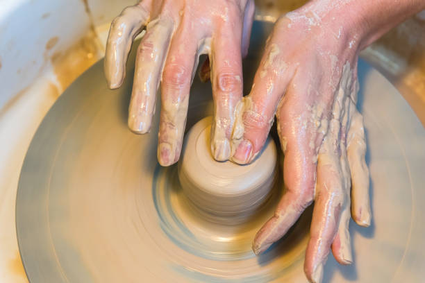 istock woman hands of a potter creating an earthen jar 911469024