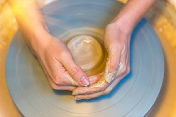 istock woman hands of a potter creating an earthen jar 911469266