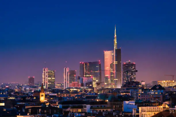 Milan skyline by night, new skyscrapers with colored lights.