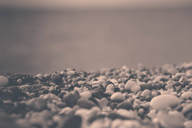 Pebbles on the shore and the sea horizon. Close-up