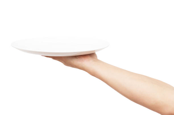 istock white plate in his hand on a white background 911474552