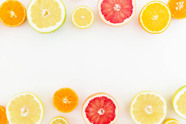 istock Citrus frame isolated on white background. Flat lay, top view. Fruit background 911477560