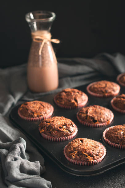 istock Muffins in baking mold and cocoa drink 911480702